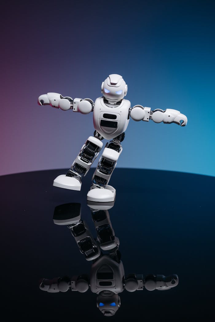 services-01 A white robot toy posed dynamically on a glossy reflective surface with a gradient background.